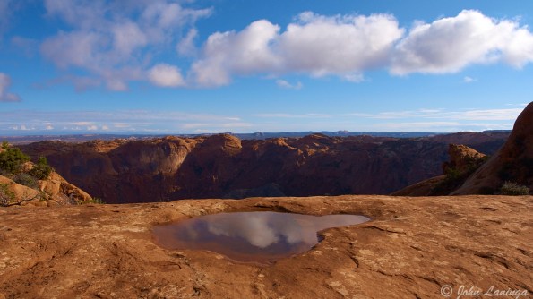 Reflecting the clouds in a rain puddle