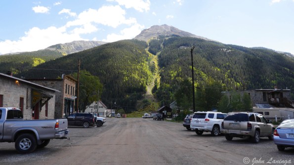 A dirt side road, big mountain in the back