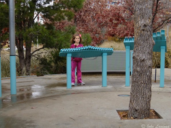 Outside, a xylophone gets the attention of a young girl