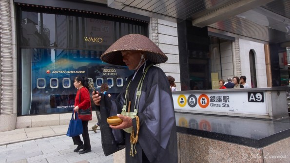 A monk loking for donations