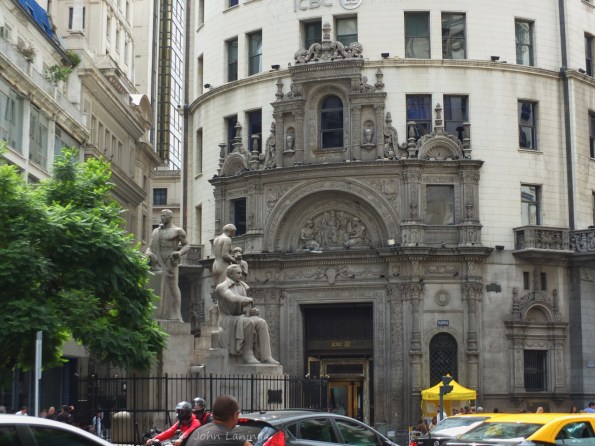 Statue with building facade