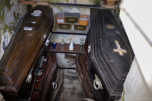 Inside one, caskets stacked on top of each other