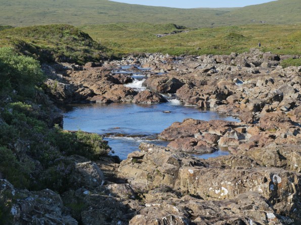 A small waterfall in volcanic rock along the way